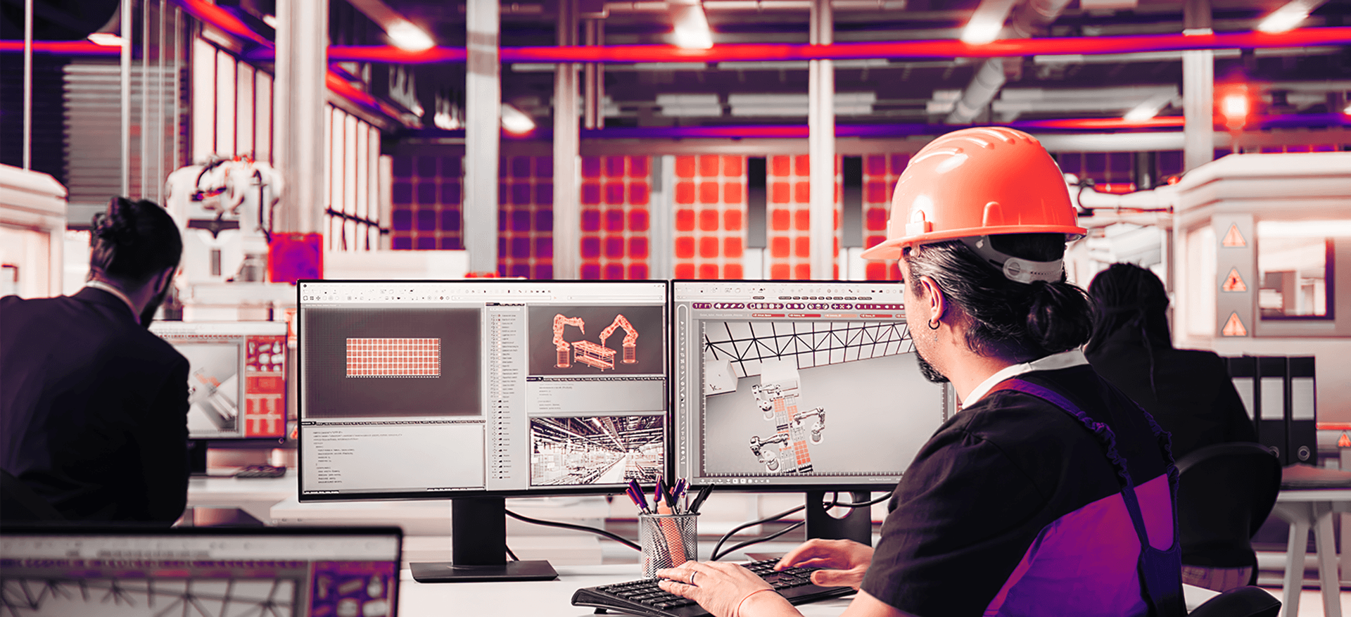 Engineer working on a computer in a factory environment
